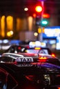 Close-up of a taxi in a traffic jam in the center of big city at night Royalty Free Stock Photo
