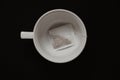 Close up of a tea cup with tea bag on the black table Royalty Free Stock Photo