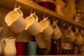 Close Up of Tea Cups Hanged on the Cupboard in English Cottage in Countryside Royalty Free Stock Photo