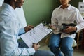 Close-up of teacher of music with musical notes having discussion with student