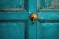 a close-up of a teal door with a vintage doorknob and keyhole