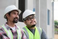 Close-up team of Asian foremen, or head engineers construction supervisors wearing white helmet, Professional supervisors looking Royalty Free Stock Photo