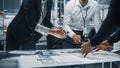 Close Up of a Team of Automotive Engineers Working in Office at Car Factory. Industrial Designer