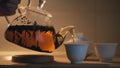 Close up of teapot with black chinese tea , gaiwan and pialas on the wooden table. Concept. Female hand poring hot Royalty Free Stock Photo