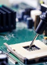 Close Up - Technician engineer measuring multimeter CPU socket computer motherboard