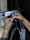 Technician hands installing network cables in server rack Royalty Free Stock Photo
