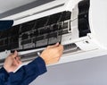 Close up technician service removing air filter of air conditioner for cleaning