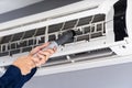 Close up technician service using vacuum cleaner to cleaning air conditioner