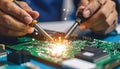 Close-up of Technician Soldering Electronic Components on a Circuit Board Royalty Free Stock Photo