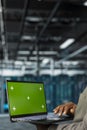 Close up of technician using green screen laptop in data center Royalty Free Stock Photo