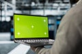 Close up of technician using green screen laptop in high tech data center Royalty Free Stock Photo