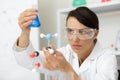 Close up technician working with erlenmeyer flask in laboratory Royalty Free Stock Photo