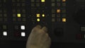 Technician operating industrial control panel with multiple buttons and lights. Stock clip Royalty Free Stock Photo