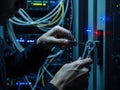 Technician Installing Network Cable in Server Room Royalty Free Stock Photo