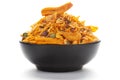 Close up of Teekha Meetha crunchy spicy Indian namkeen snacks on a ceramic black bowl