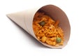 Close up of Teekha Meetha crunchy spicy Indian namkeen snacks In handmade handcraft brown paper cone bag