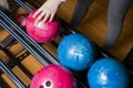 Close-up on teen children hand holding bowling ball against bowling alley - Image. Cheerful Kids are ready to play - Image. The