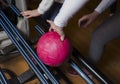 Close-up on teen children hand holding bowling ball against bowling alley - Image. Cheerful Kids are ready to play - Image. The