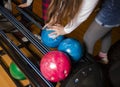 Close-up on teen children hand holding bowling ball against bowling alley - Image. Cheerful Kids are ready to play - Image. The