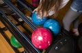 Close-up on teen children hand holding bowling ball against bowling alley - Image. Cheerful Kids are ready to play - Image. The