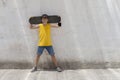 A teenage boy carrying skateboard and smiling Royalty Free Stock Photo