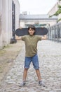 A teenage boy carrying skateboard and smiling Royalty Free Stock Photo