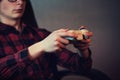 Close up of teenage boy hands playing video games holding a joystick console, seated relaxed in his room. Focused guy having fun Royalty Free Stock Photo