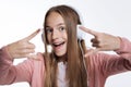 Close up of teenage girl showing sign of horns