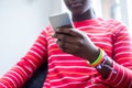 Close Up Of Teenage Girl Wearing Wristbands Using Mobile Phone At Home