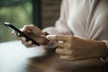 Close up of a teenage woman holding credit card and smart phone make online payment Royalty Free Stock Photo