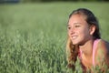 Close up of a teenager girl smiling in an oat meadow