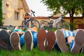 Close up of teenagers feet in sneakers while lying on the grass