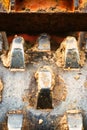 A close up of the teeth on a large soil compactor.