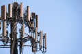 Close up of telecommunications cell phone tower with wireless communication antennas; blue sky background and copy space on the Royalty Free Stock Photo