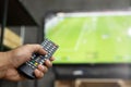 Close up Television remote control in casual man hands pointing to tv Royalty Free Stock Photo