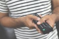 close up Television remote control in casual man hands pointing to tv