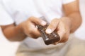 Close up Television remote control in casual man hands pointing to tv Royalty Free Stock Photo