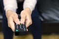 Close up Television remote control in casual woman Royalty Free Stock Photo