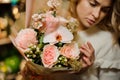 Close-up of tender pink bouquet of orchids and roses in woman`s hands