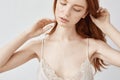 Close up of tender redhead girl in sleepwear posing with closed eyes. Royalty Free Stock Photo