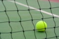 Close up Tennis ball and blur net on court background Royalty Free Stock Photo