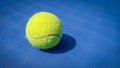 A close-up of the tennis ball on the court. The blue background is a beautiful illustration and background. Close-up shots of tenn Royalty Free Stock Photo