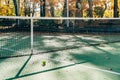 Close up of tennis ball next to empty tennis court