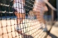 Close up of tennis net on summer sunny day. Modern lifestyle with sport and fitness details