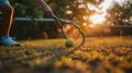 close up of tennis raquet in hand and ball on a green grass summer field Royalty Free Stock Photo