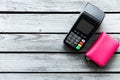 Top view of terminal and pink wallet with copy space. Contactless payment method Royalty Free Stock Photo
