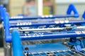 Close up of TESCO shopping trolley - blue handles