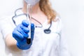 Close up. A test tube with blood in the hands of a female virologist. Laboratory research, search for a vaccine against the