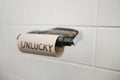 Close-up of text written on empty toilet paper roll in bathroom Royalty Free Stock Photo