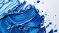 Close-up of textural strokes of blue paint. Splashes of blue paint on a white background. The spray has a wave shape, and the blue Royalty Free Stock Photo